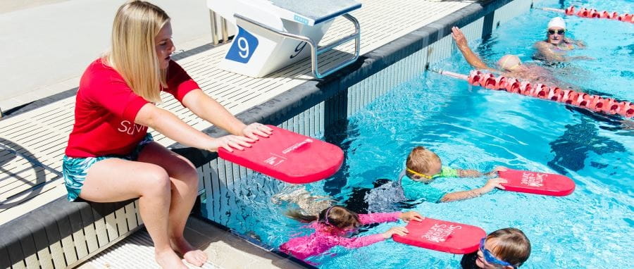 swim instructor with young students