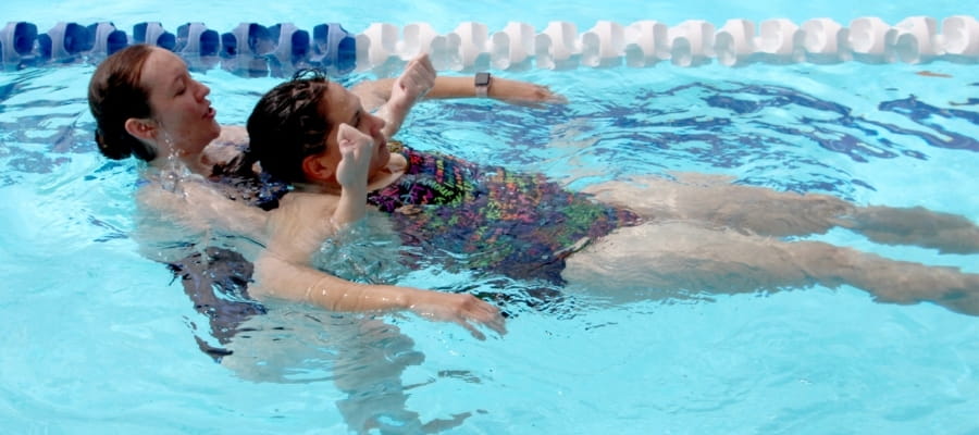person performing a contact tow during an aquatic rescue simulation