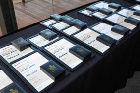 Bravery Awards medals and framed certificates sitting on a table