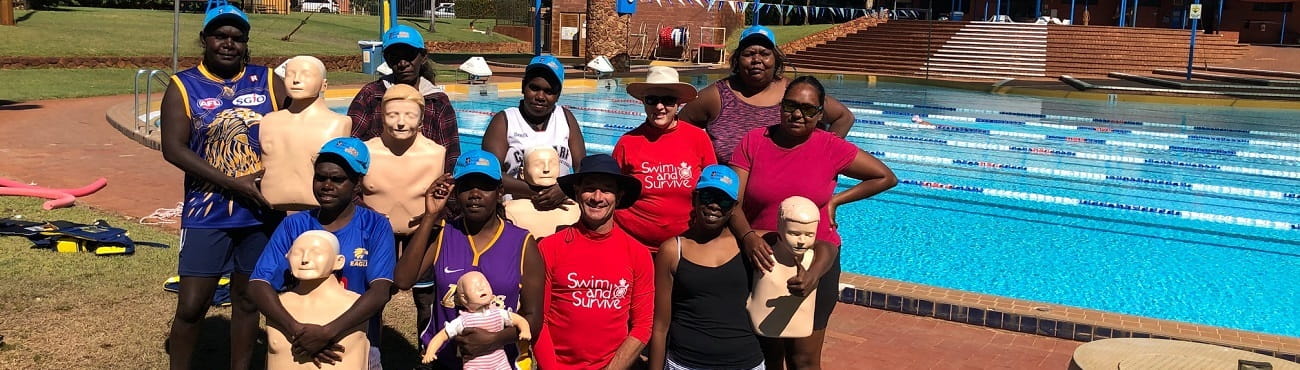 Group of Aboriginal young people at a local pool with their bronze medallion instructors