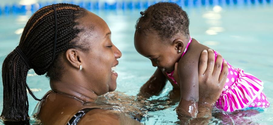 An African mum and baby in a pool
