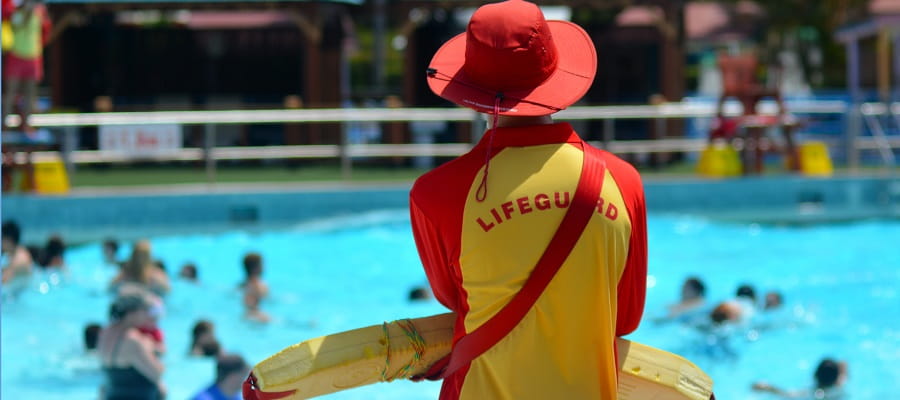 lifeguard surveying public swimming pool