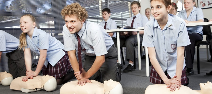 high school class learning how to perform CPR