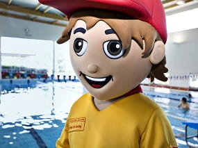 Lifeguard mascot standing at the edge of pool