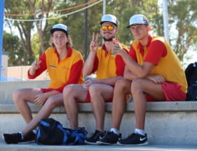 Image of 3 pool lifeguards sitting in the stands waiting for their events