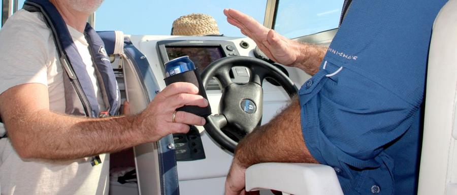 man refusing a tinny while boating