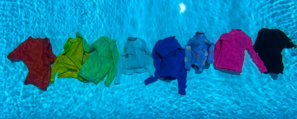 Different coloured bathers submerged to demonstrate their visibility under water