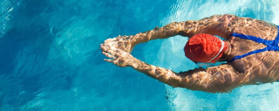 image of a person swimming head down in a pool with arms out in front