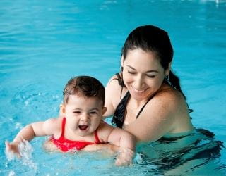 image of mother with baby enjoying a swimming lesson