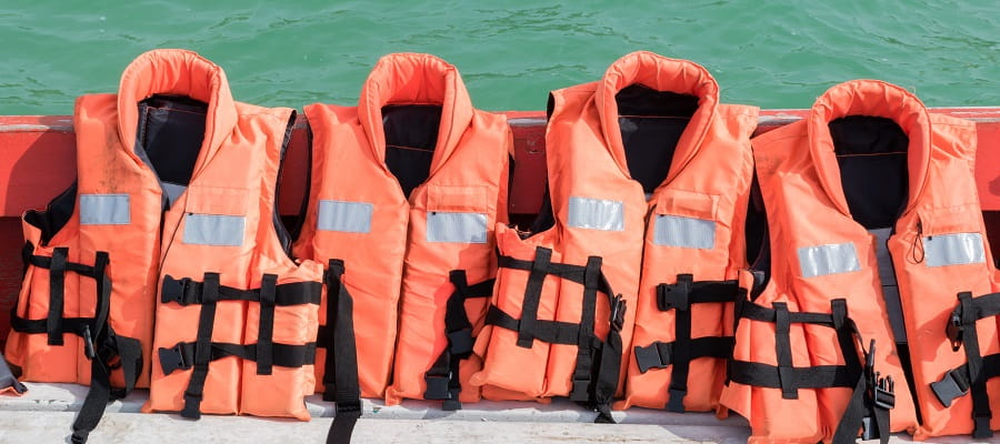 four lifejackets lined up in a boat